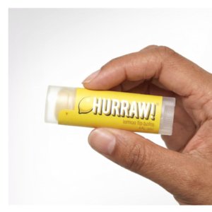A tube of Hurraw Lemon Lip Balm with a bright yellow label.