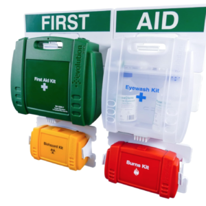 A large green wall‑mounted first aid point with multiple stocked kits, including first aid, eyewash, burns, and biohazard units.